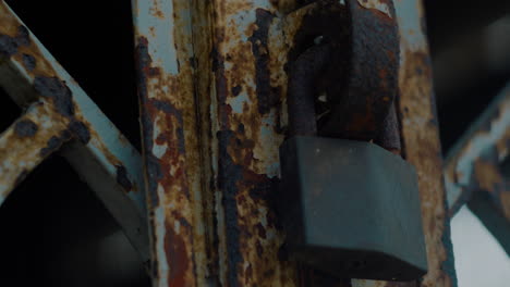 the rusted iron door was locked with an old lock