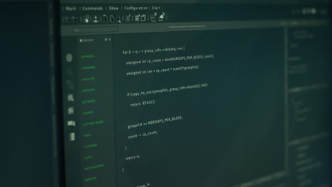 Close up of lines of code running on computer display in modern data center
