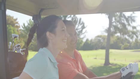 two golfers driving in their golf buggy