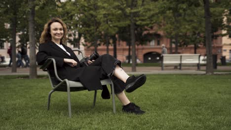 woman sitting in a park with a camera