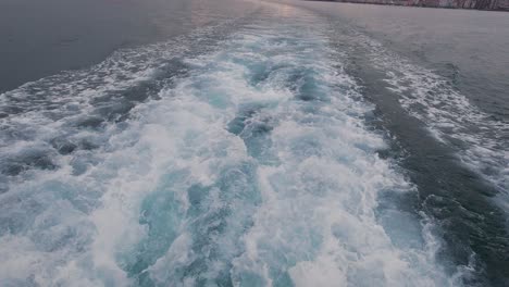 white foaming sea water comming out from ferry boat jet powered engine santander bay view from a ferry boat during sunset cloudy summer day-1