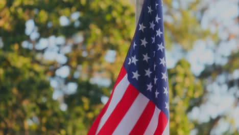 close up of waving american flag fabric with stars and stripes on flagpole