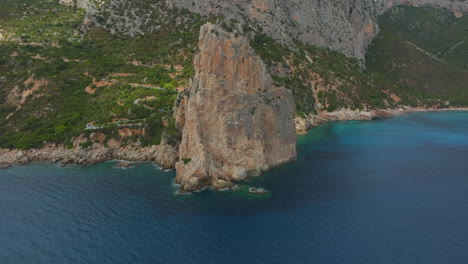 aerial view in orbit over the monolite di pedra longa on the island of sardinia on a sunny day with beautiful colors