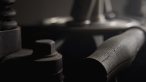 Still-shot-of-a-printing-machine,-some-wooden-parts-and-some-iron-parts-cowered-with-dust,-grime-and-cobwebs