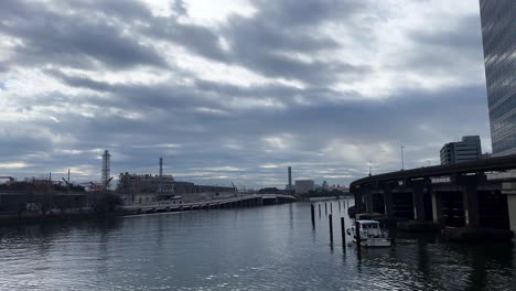 a cloudy urban river view in tokyo, japan, showcasing calm water and cityscape