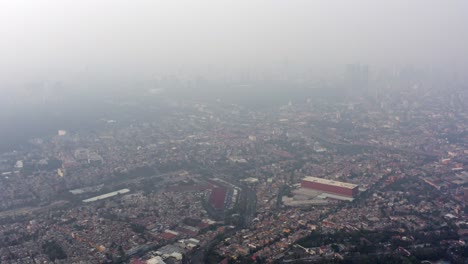 aerial wide shot of mexico city with a lot of pollution