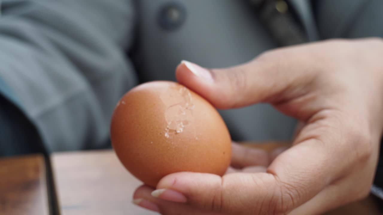 Person holding a cracked egg