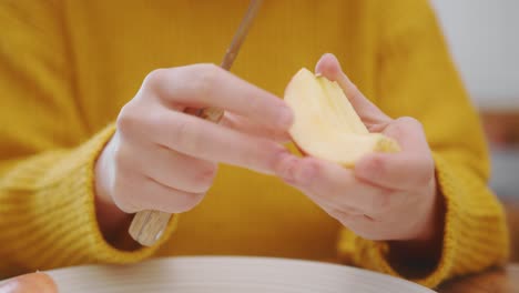 Woman’s-Hands-Cutting-And-Eating-An-Apple---Close-Up