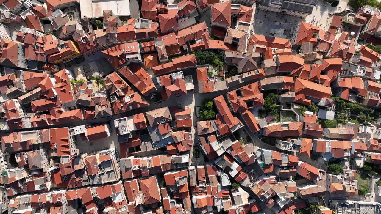 Red-tiled rooftops and winding streets in sibenik, croatia, aerial view