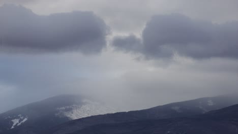 timelapse of moving clouds in mountains with snow