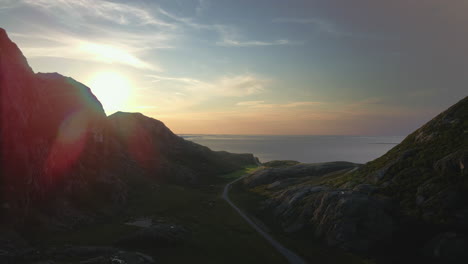 beautiful sunset behind the mountain in dønna, nordland county, norway - aerial drone shot