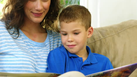 mom and son looking at a book