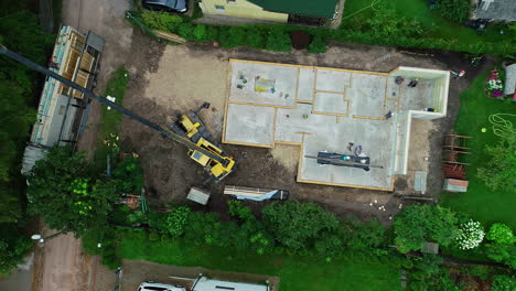 above view of a hydraulic tractor crane working in construction site