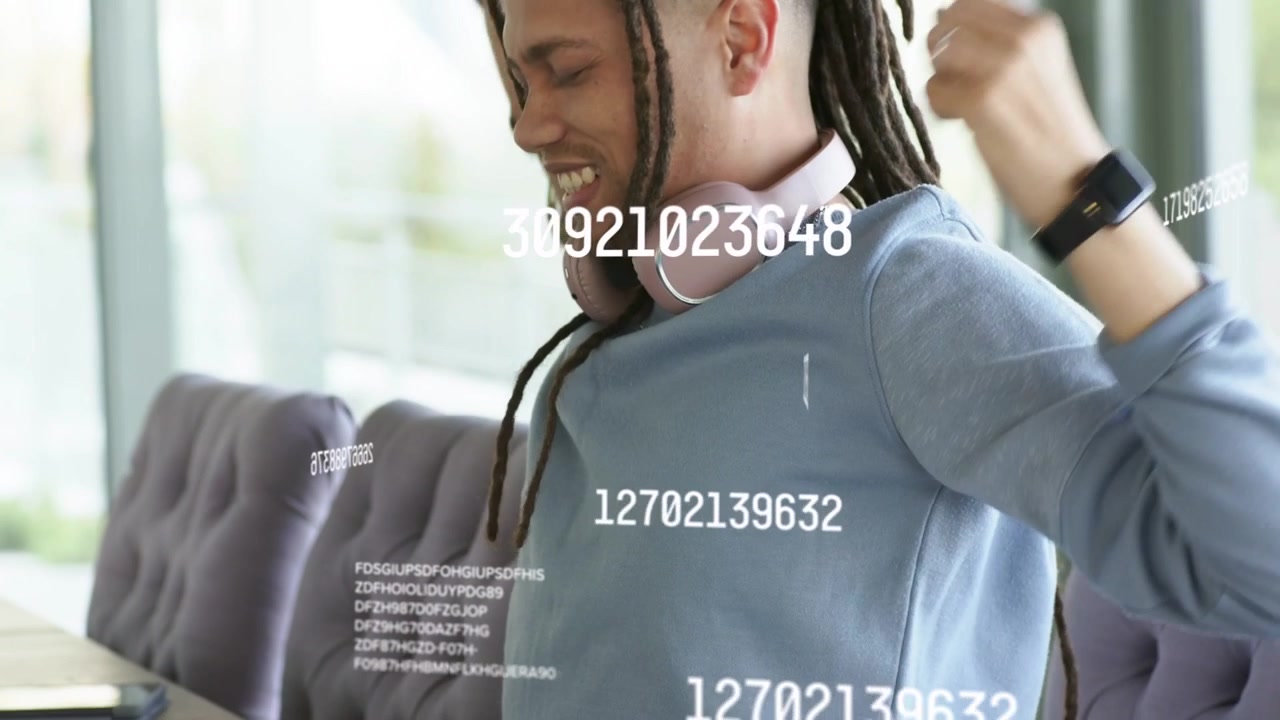 Man reacting to laptop data overlay, stretching, adjusting headphones, leaning in, typing for tech