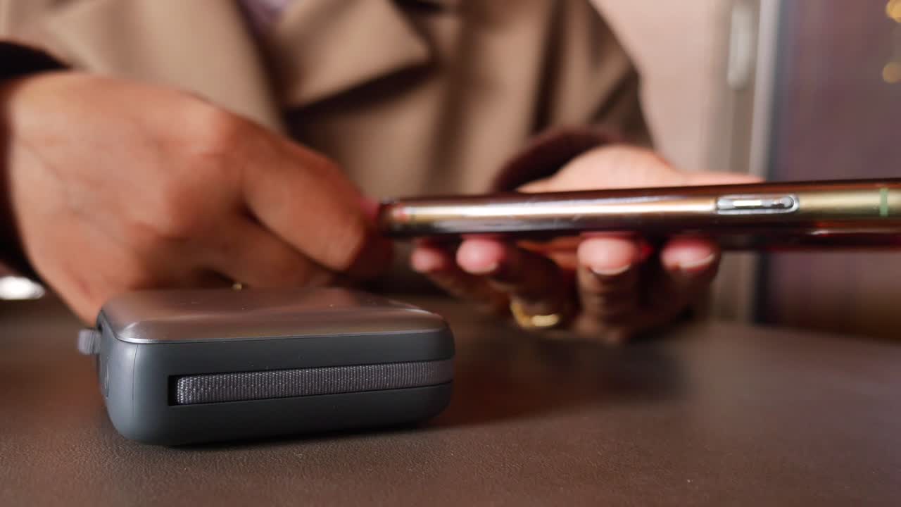 Person Connecting Portable Charger to Smartphone