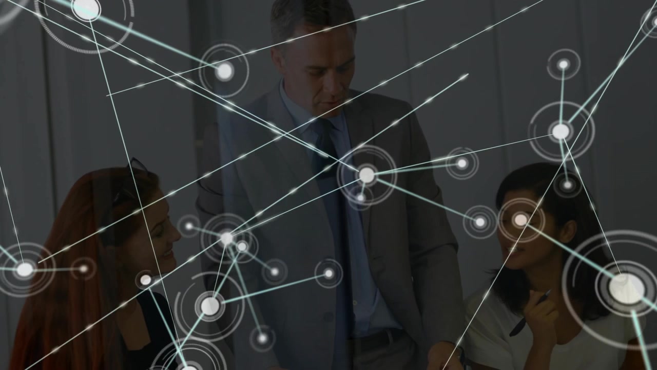 colleagues reviewing document starting network graphic growing across table showing corporate links