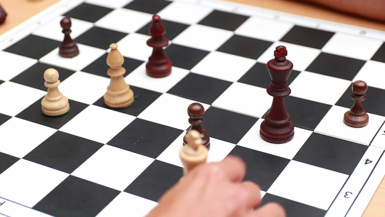 Two person are playing chess. Chess pieces on the board. People are playing chess on a wooden background
