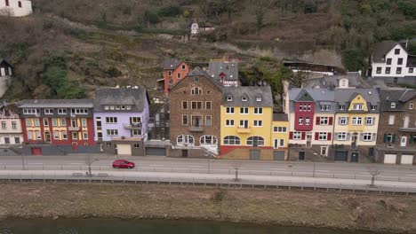 downward tilting drone footage with a view of the typical houses on the banks of the moselle river in the german city of cochem