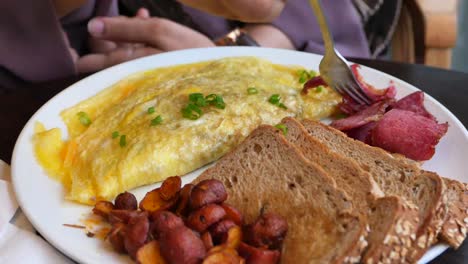 delicious omelette breakfast with toast and potatoes