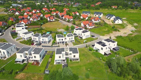 Aerial-view-of-residential-houses-neighborhood-and-apartment-building-complex-at-sunset