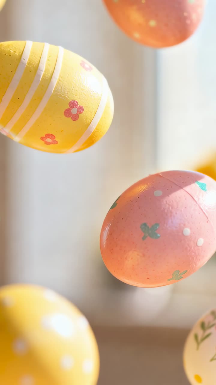 Vertical video: Entering left decorated pastel eggs rotating drifting by window, revealing patterns