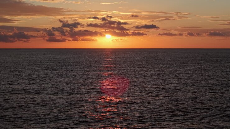 Golden Sunset Over Calm Ocean with Sun Reflection