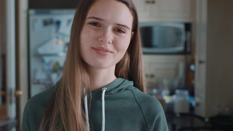 portrait beautiful teenage girl in kitchen at home smiling happy enjoying carefree lifestyle