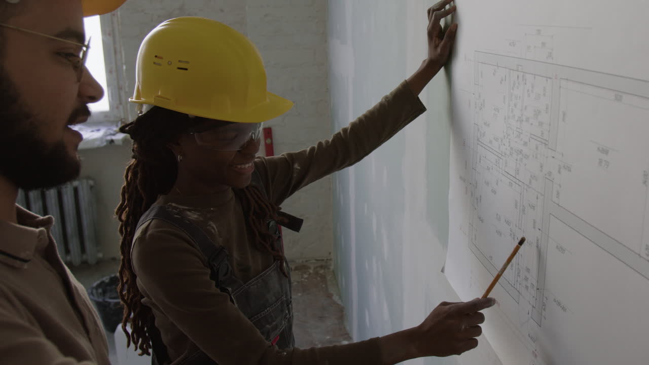 Construction workers discussing a blueprint