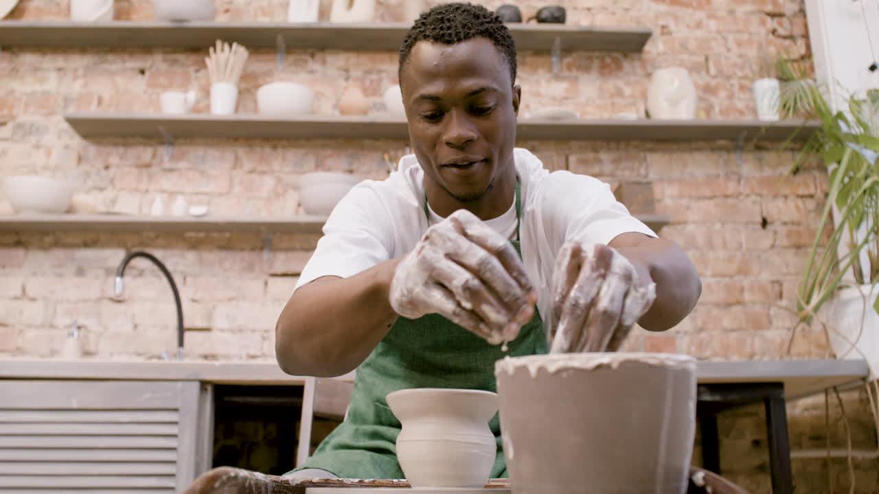 Bottom View Of American Clerk Man Modeling Ceramic Piece On A Potter Wheel In A Workshop 1