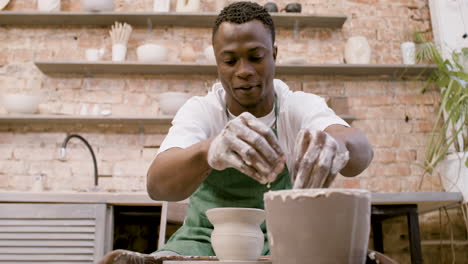 Bottom-View-Of-American-Clerk-Man-Modeling-Ceramic-Piece-On-A-Potter-Wheel-In-A-Workshop-1