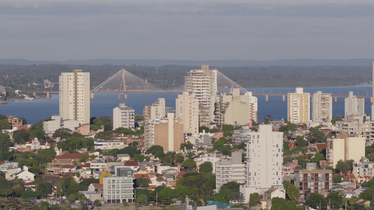 Bright aerial skyline of the Posadas city with high-rise buildings and bridge view, Misiones, Argentina.