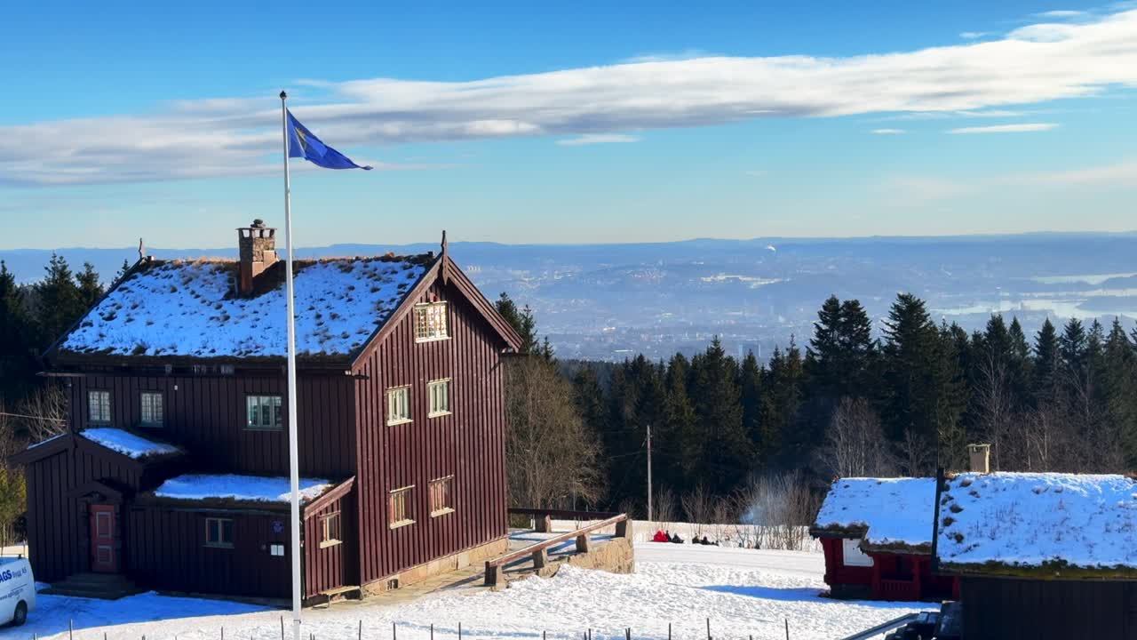Frognersteteren restaurant cabin lodge Skimore Oslo Holmenkollen Ski Jump Cross Country Ski resort Norway Norge winter daytime sunny clouds Oslo cityscape Inner Fjord view sledding Norwegian flag