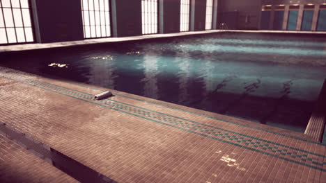 the view of an empty public swimming pool indoors