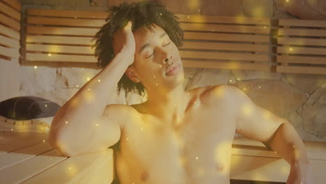 relaxing in sauna, man surrounded by glowing particles