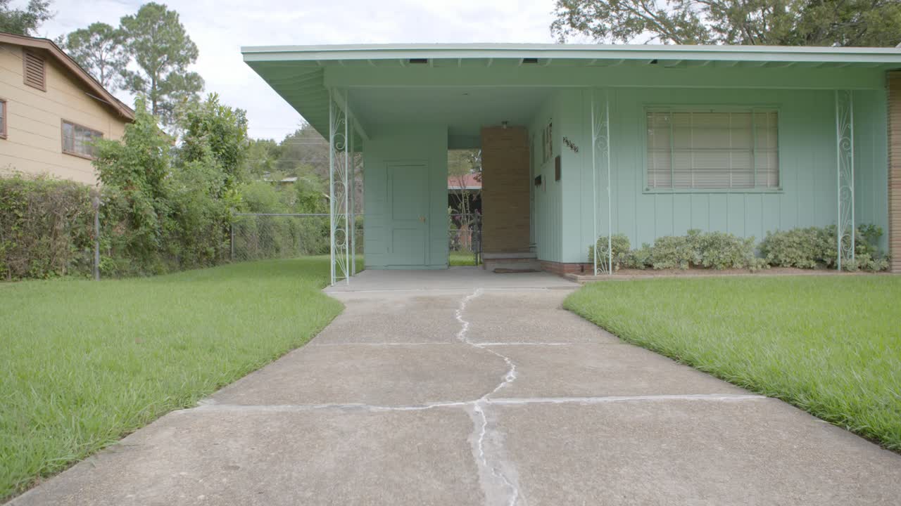 Wide: Rack focus out to blur. Civil rights leader Medgar Evers home. Site of his assassination. Jackson, Mississippi.