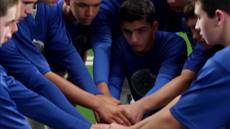 young athletes huddling on a sports field