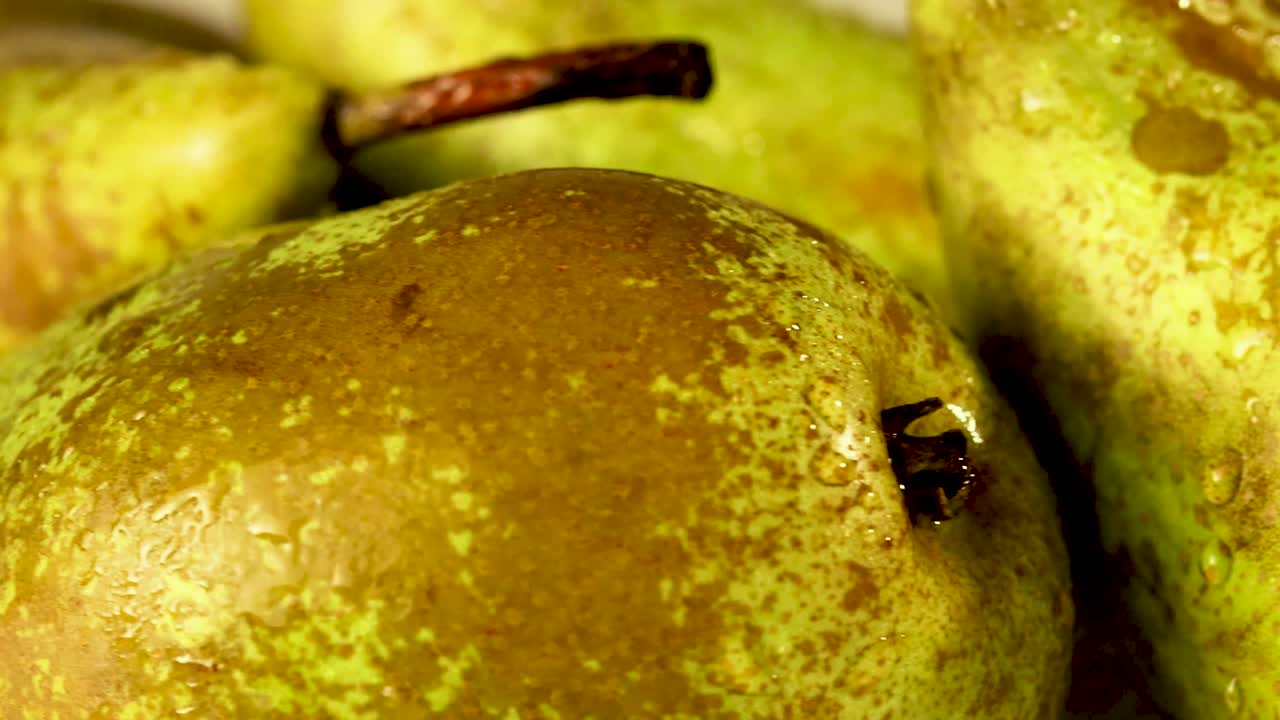 Detail moving shot of a few pears with waterdrops