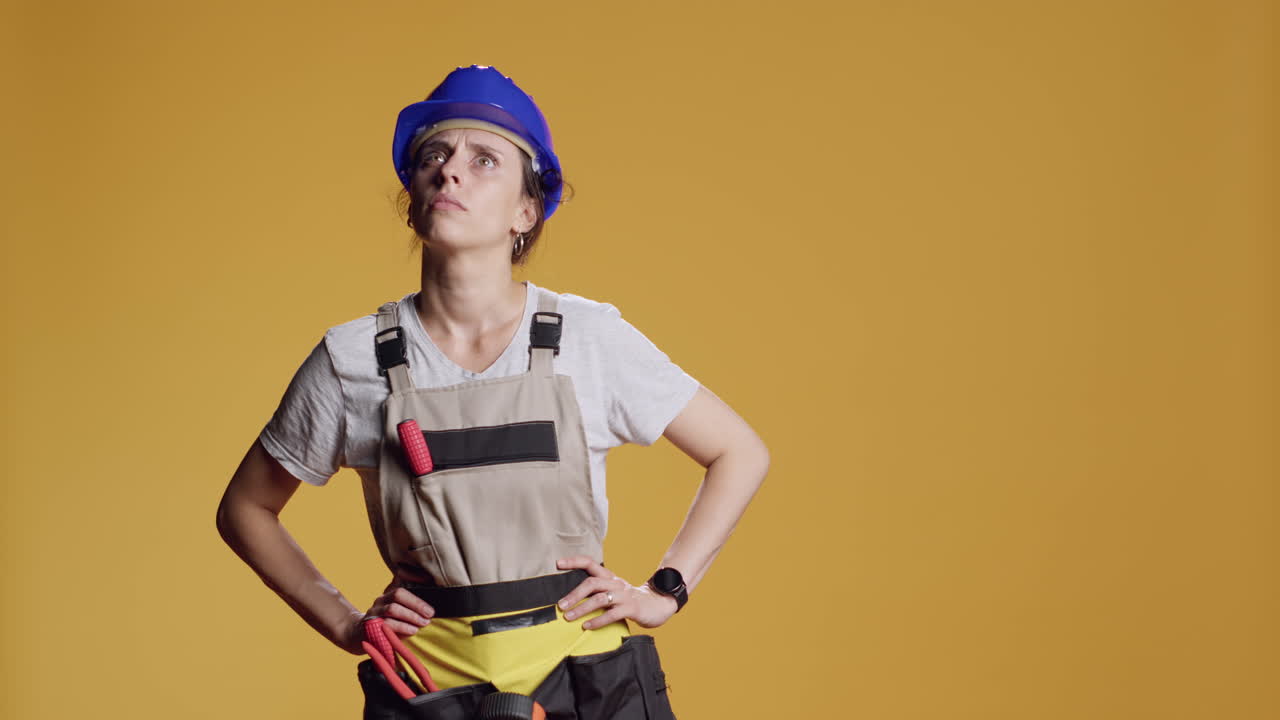 Portrait of female construction worker being dizzy and seeing cartoonish stars