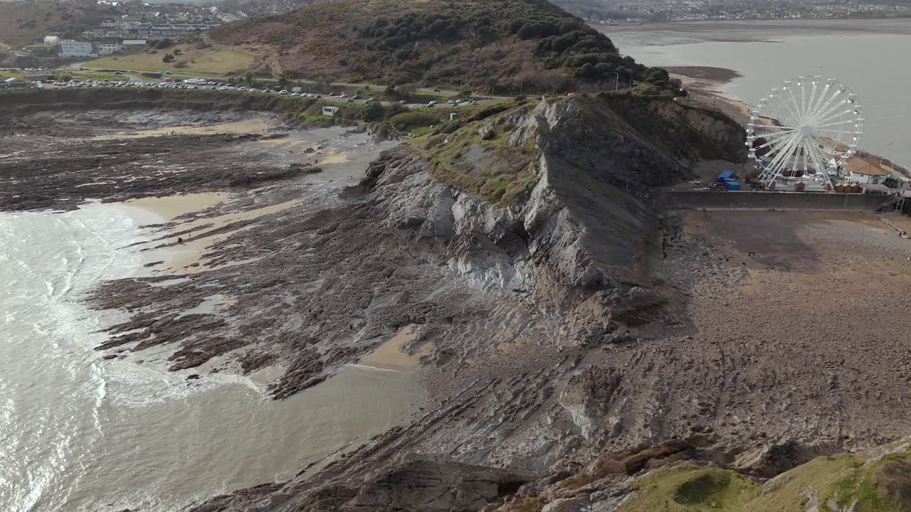 Drone shot of The Big Wheel at Mumbles Pier Swansea in United Kingdom during daytime.