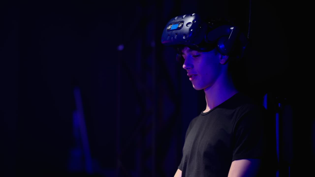 Boy playing with a Virtual Reality headset in a studio