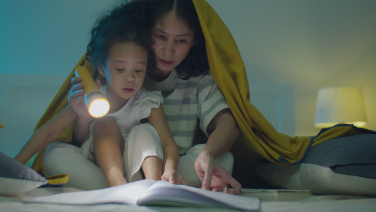 Asian Girl and Mom Reading Fairytale on Bed at Night
