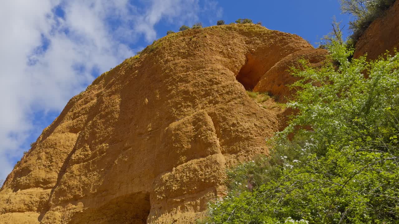 Breathtaking Golden Mountains Surrounded By Vegetation With A Small Opening