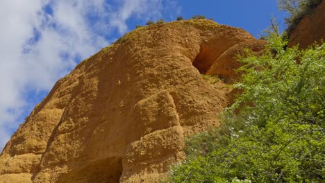 breathtaking golden mountains surrounded by vegetation with a small opening