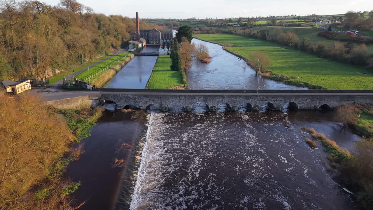 Water Flowing On The Boyne River With Weir In Slane, County Meath, Ireland. - aerial shot