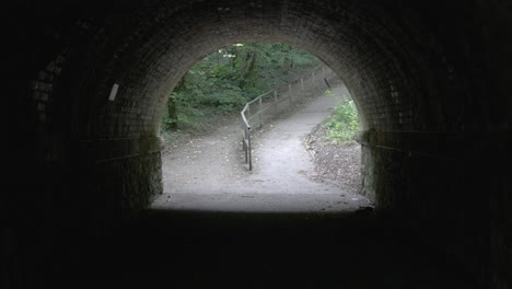 bright park walk at the end of a dark tunnel