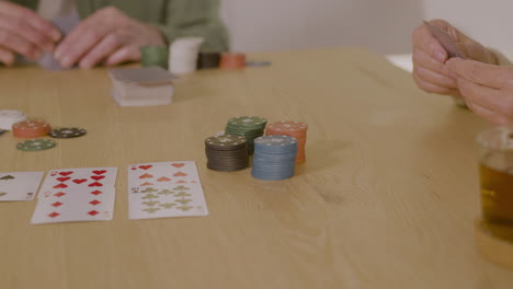 Close-Up-Of-Unrecognizable-People-Playing-Poker-At-Home