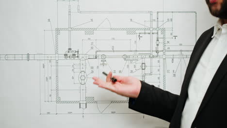 professional explaining a technical engineering blueprint