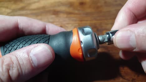 pocket handheld ratchet with attaching nut wrench to fasten and fix a bolt