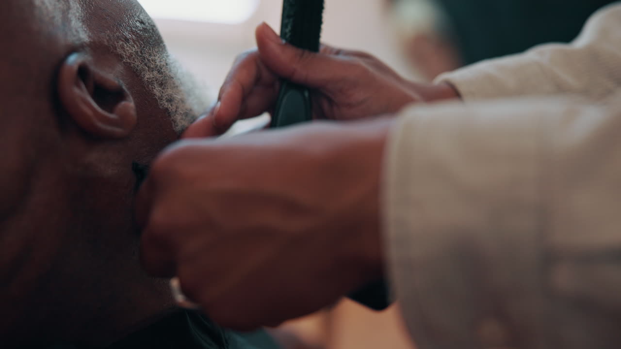 Close Up of Barber Trimming Hair of an Older Man