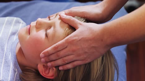 physiotherapist giving head massage to a boy 4k